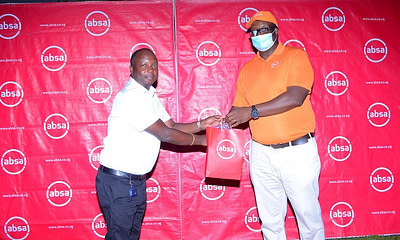 absa uganda official poses for a picture at the event