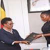 GG Beti Kamya (L) hands over a report to Commissioner Afoyochan