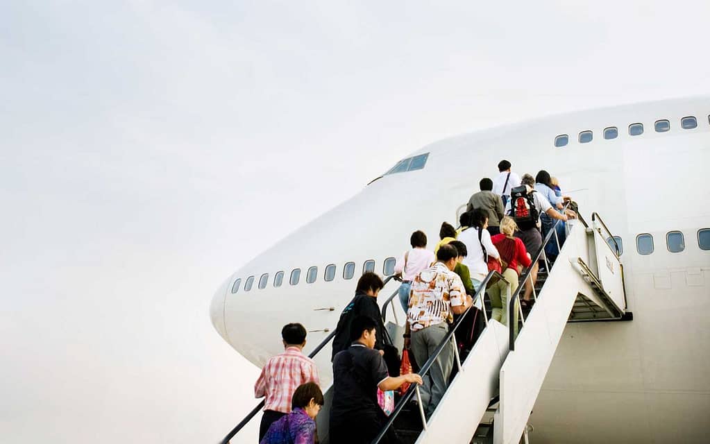 Passengers board a plane