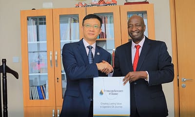 The new President of CNOOC Uganda Limited, Mr. Liu Xaingdong (L) poses with Mr. Ernest Rubondo, the Executive Director of the Petroleum Authority of Uganda (R)