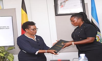 GG Beti Kamya (L) hands over a report to Commissioner Afoyochan