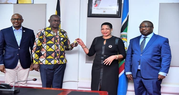 A-picture-of-the-Speaker-of-Parliament-handing-over-keys-to-the-radio-equipment-to-MD-UBC-Agaba-Winston-in-the-presence-of-the-Clerk-to-Parliament-and-Depty-MD-UBC-Maurice-Mugisha